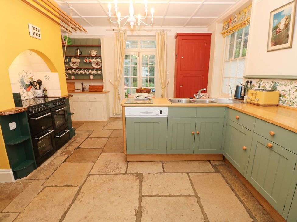 A kitchen with cabinets and an oven at Woodlands in Freshwater