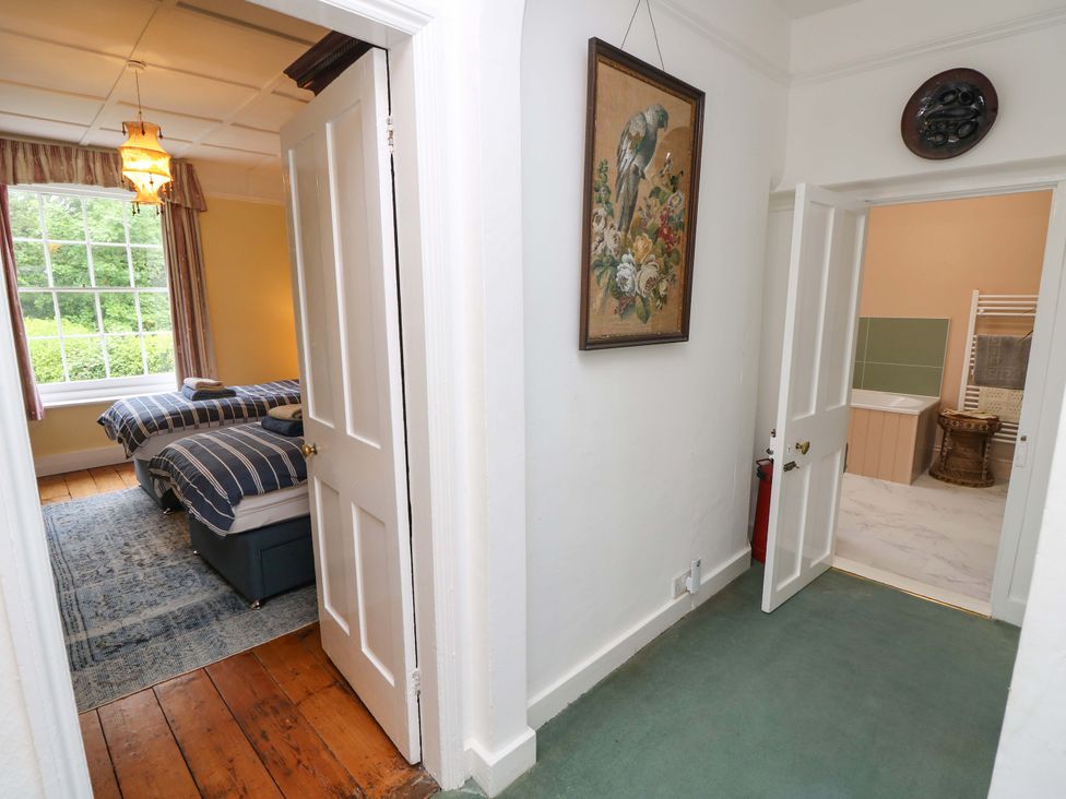 A hallway leading to a bedroom and bathroom at Woodlands in Freshwater