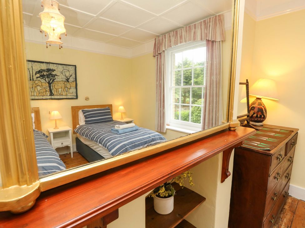 A bedroom with two beds and a window at Woodlands in Freshwater