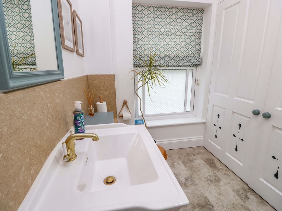 A bathroom with a sink and mirror at Woodlands in Freshwater