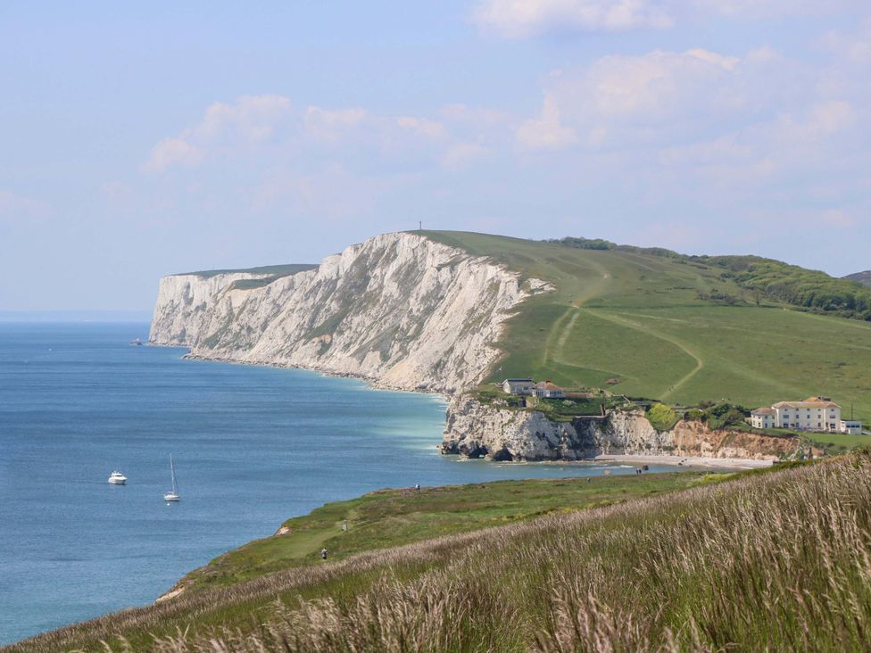 A coastal view with cliffs and boats at Woodlands Freshwater
