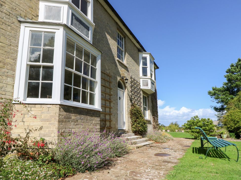 A house exterior with garden and pathway at Woodlands, Freshwater