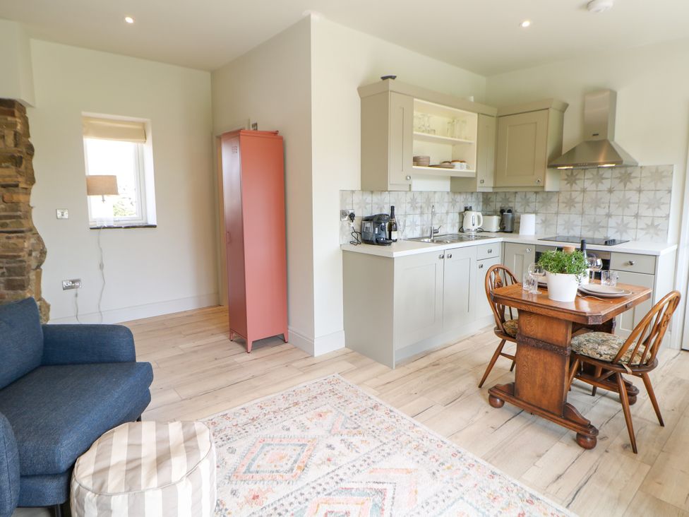 A kitchen with a dining area and seating at The Plucking Shed in Stockport