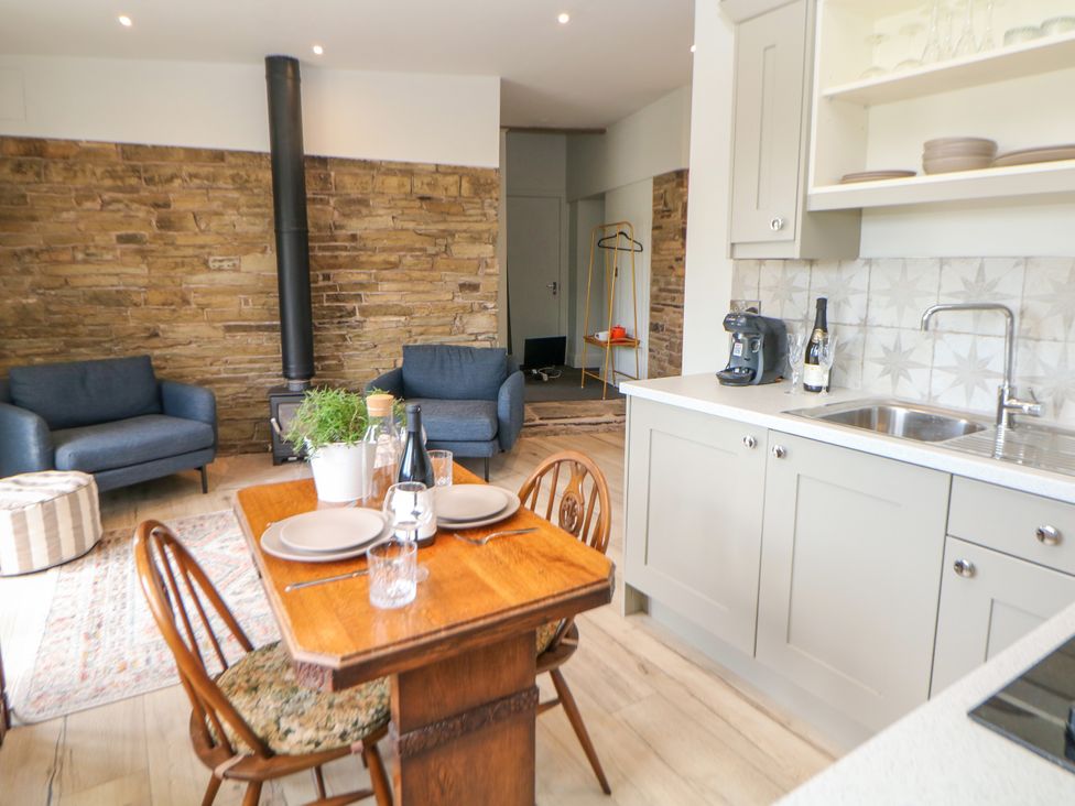 A kitchen with a dining table and chairs at The Plucking Shed in Stockport