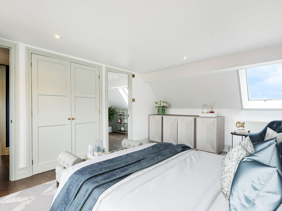 A bedroom with a bed and wardrobe at Higginson House in Marlow