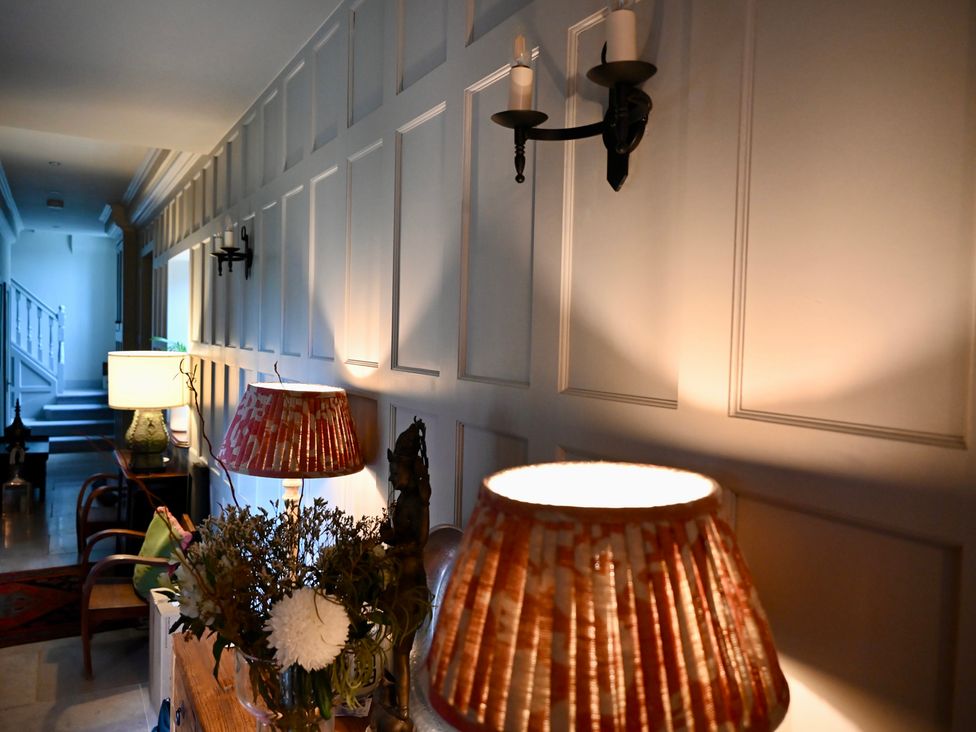 A hallway with wall decor and lamps at Higginson House, Marlow