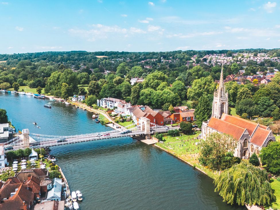 An aerial view of a river with a bridge and a church at Higginson House in Marlow
