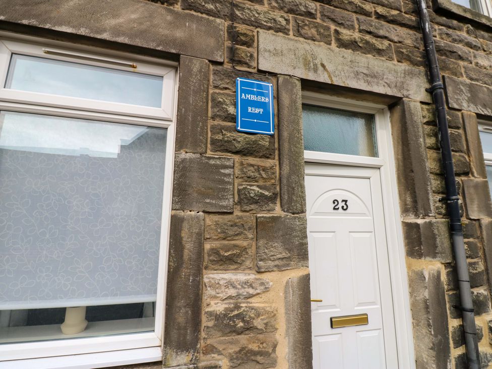 A white door and window with a nameplate at Amblers Rest in Amble