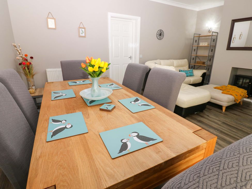 A dining room with a table and chairs at Amblers Rest in Amble
