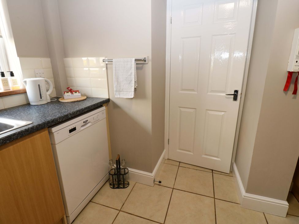 A kitchen with a kettle and dishwasher at Amblers Rest in Amble