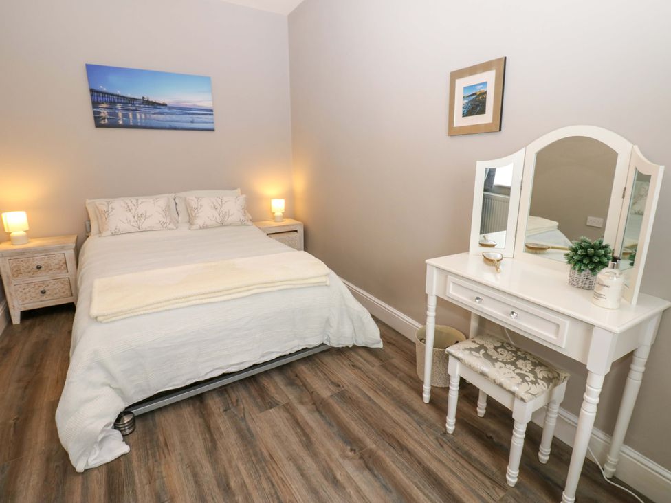 A bedroom with a bed and vanity at Amblers Rest in Amble
