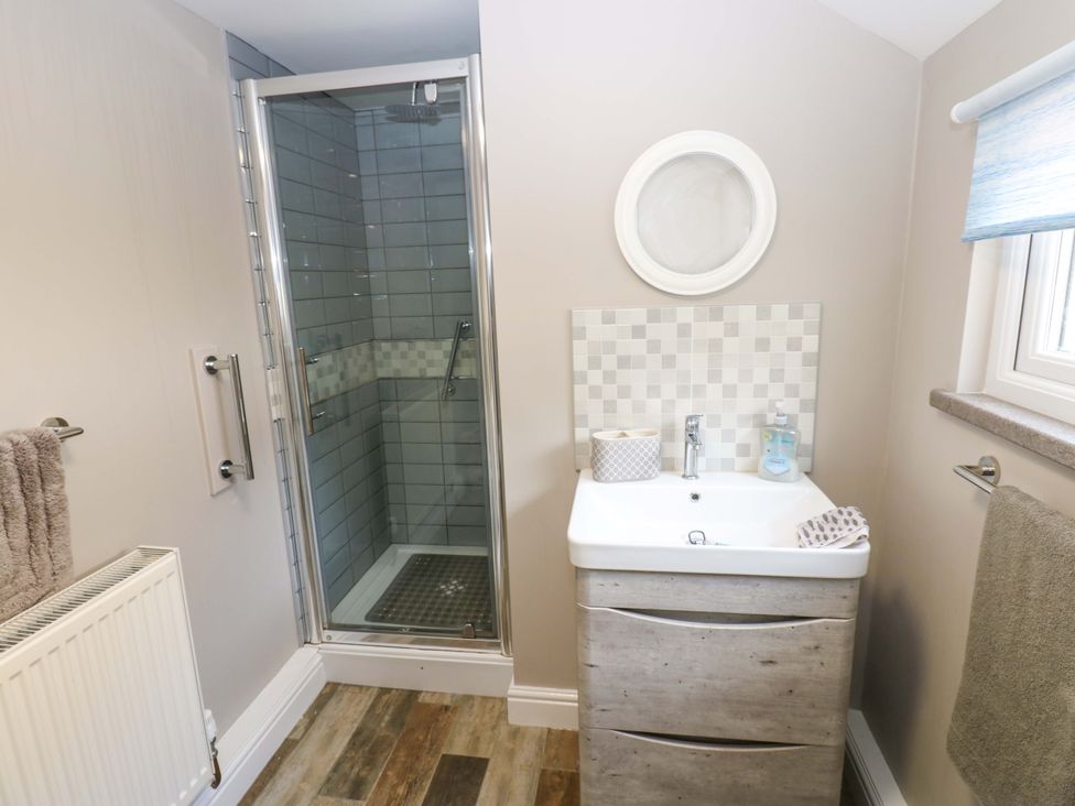 A bathroom with a shower and sink at Amblers Rest in Amble