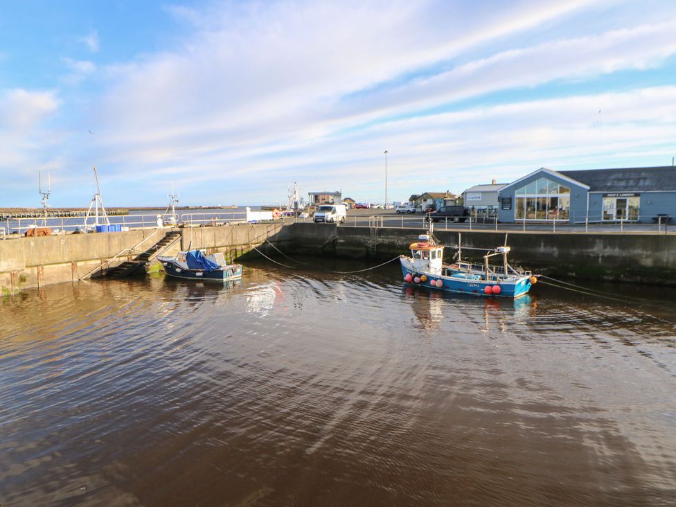 A harbor with boats and a building at Amblers Rest in Amble