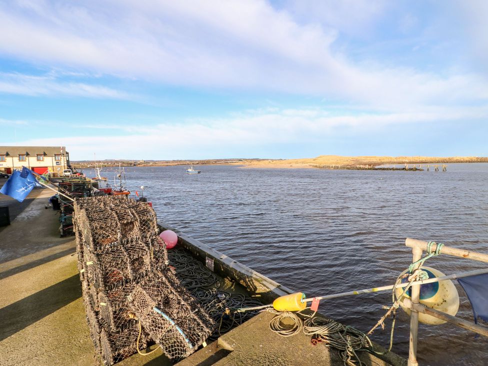 A view of a river with fishing equipment and boats at Amblers Rest in Amble