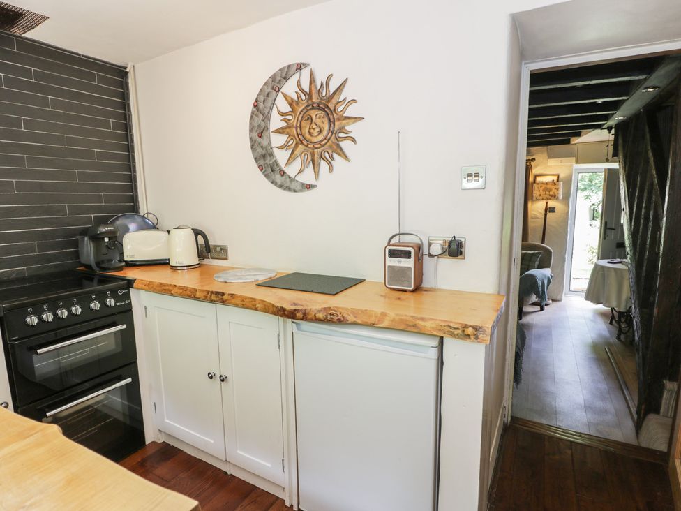 A kitchen with an oven and appliances at Squirrel Cottage in Betws-Y-Coed
