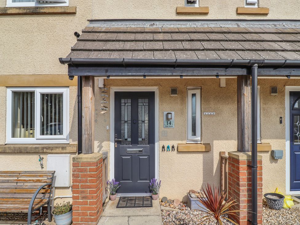 A house entrance with a front door and windows at Tidal Watch in Seahouses