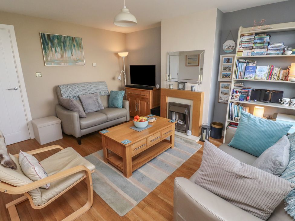 A living room with a coffee table and sofa at Tidal Watch in Seahouses