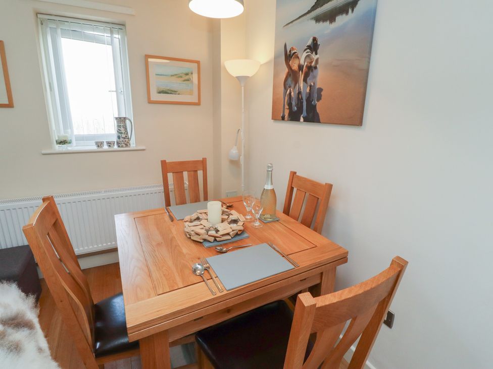 A dining room with a table set for meals at Tidal Watch in Seahouses
