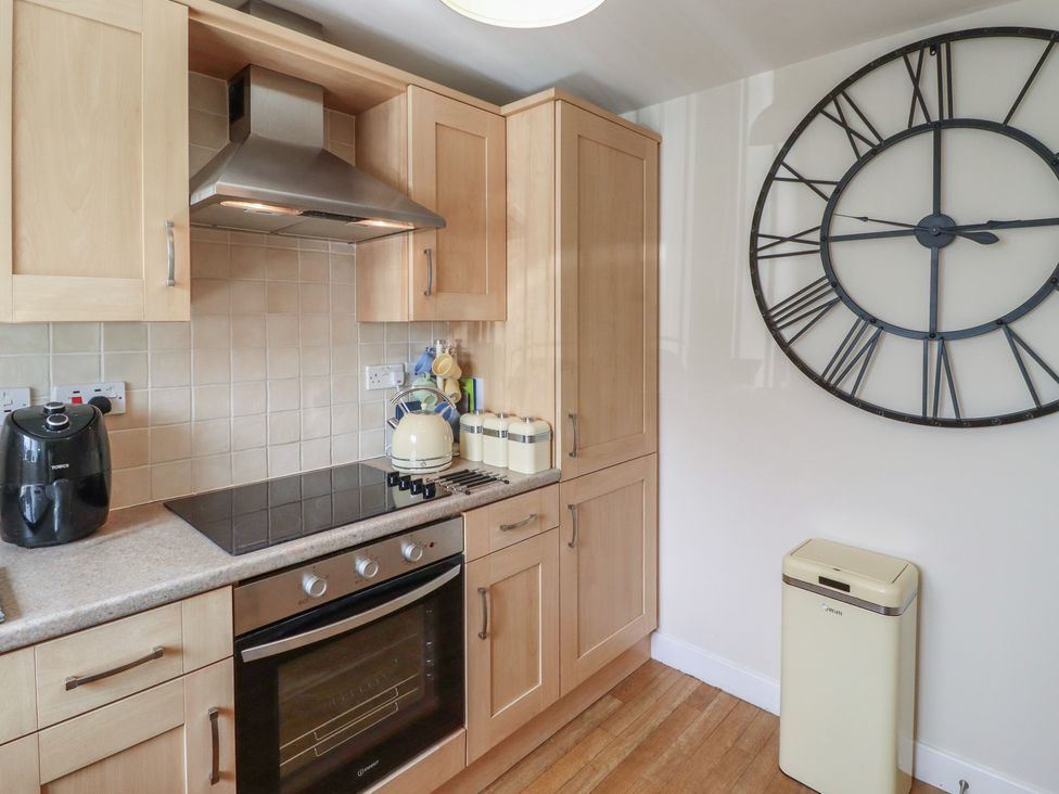 A kitchen with cabinets and appliances at Tidal Watch in Seahouses