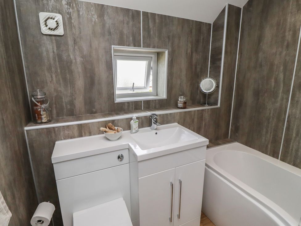 A bathroom with a sink, toilet, and bathtub at Tidal Watch in Seahouses