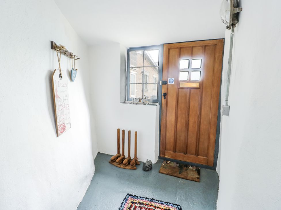An entrance hall with a door and a window at The Old Cornmill in Cemaes Bay