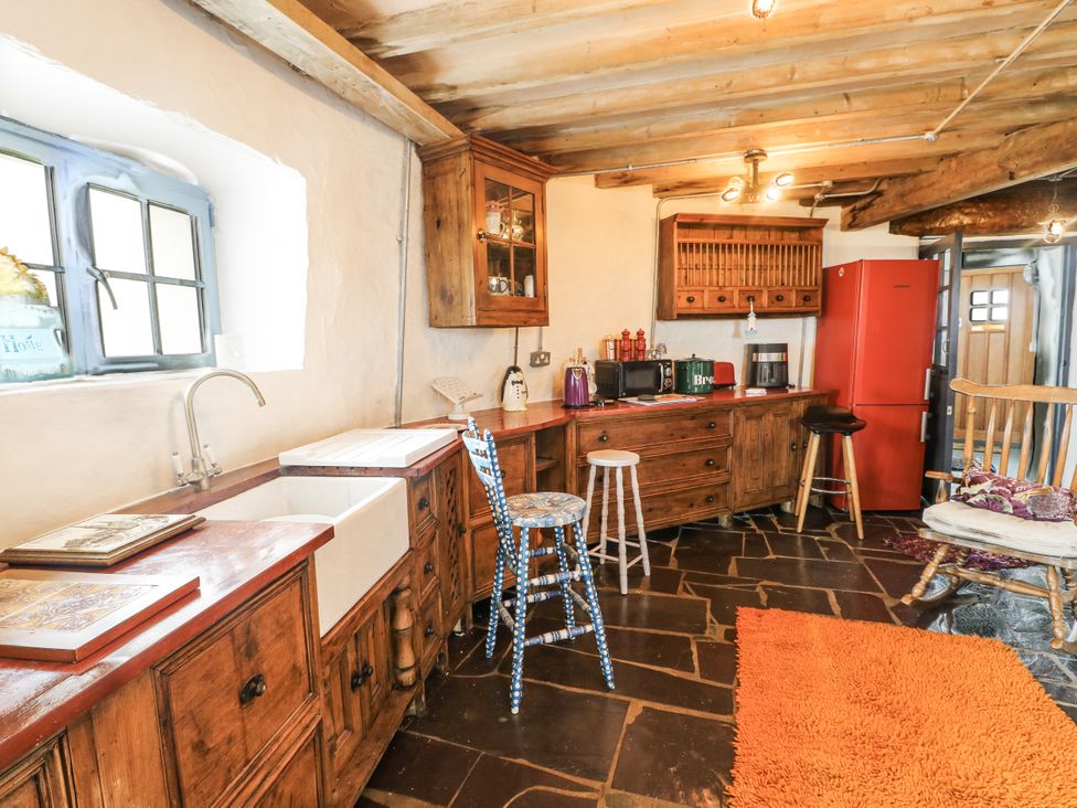 A kitchen with cabinets and a sink at The Old Cornmill in Cemaes Bay