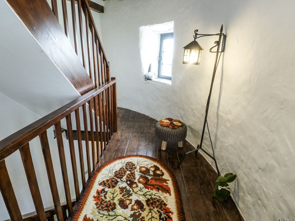 A stairway with a window and a lamp at The Old Cornmill in Cemaes Bay