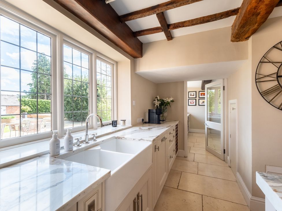 A kitchen with sinks and windows at Hall O'Coole in Broomhall nearn Wrenbury