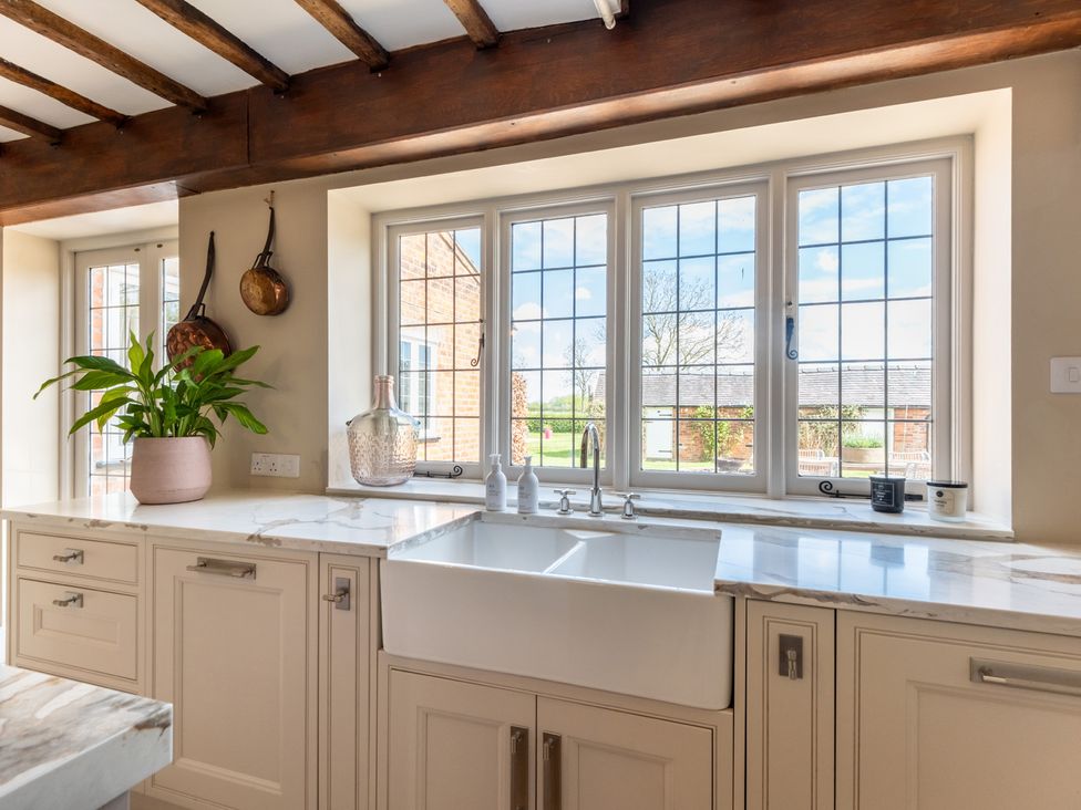 A kitchen with a sink and window at Hall O'Coole in Broomhall nearn Wrenbury