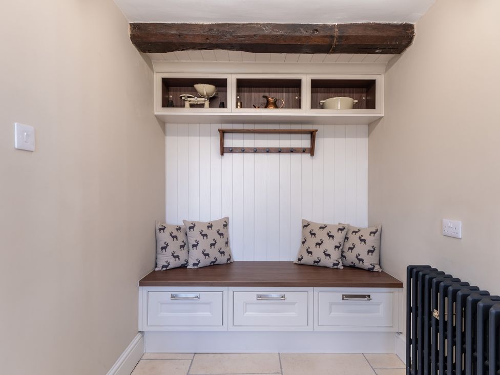 A hallway with a bench and shelf at Hall O'Coole in Broomhall nearn Wrenbury