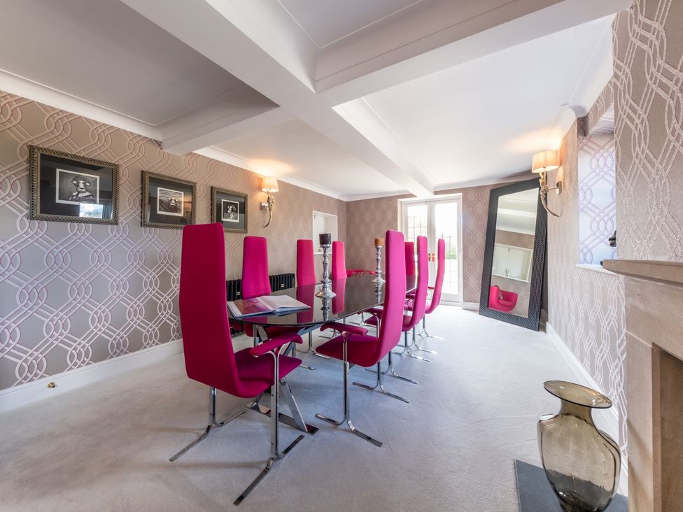 A dining room with pink chairs and a glass table at Hall O'Coole in Broomhall nearn Wrenbury