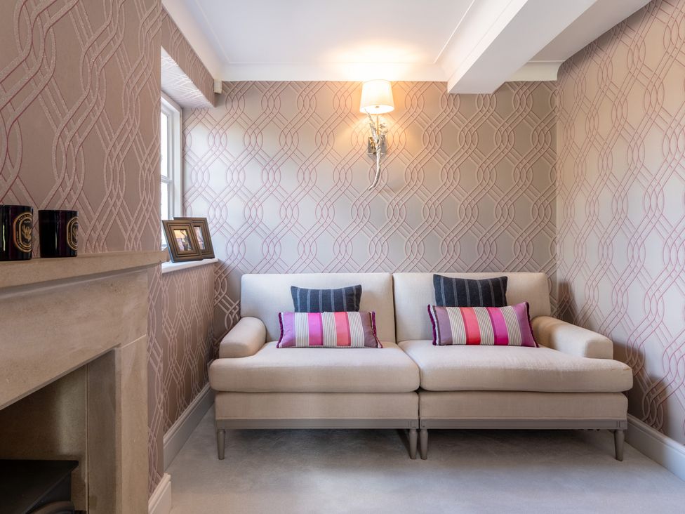 A living room with a sofa and pillows at Hall O'Coole in Broomhall nearn Wrenbury