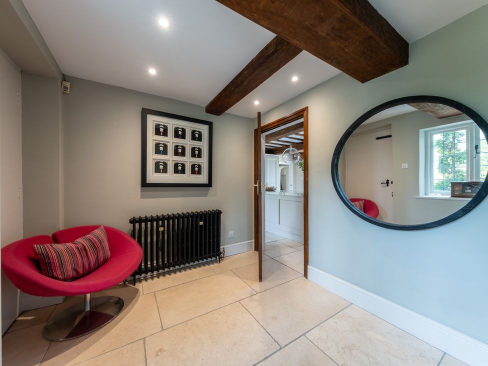 A hallway with a chair and a radiator at Hall O'Coole in Broomhall nearn Wrenbury