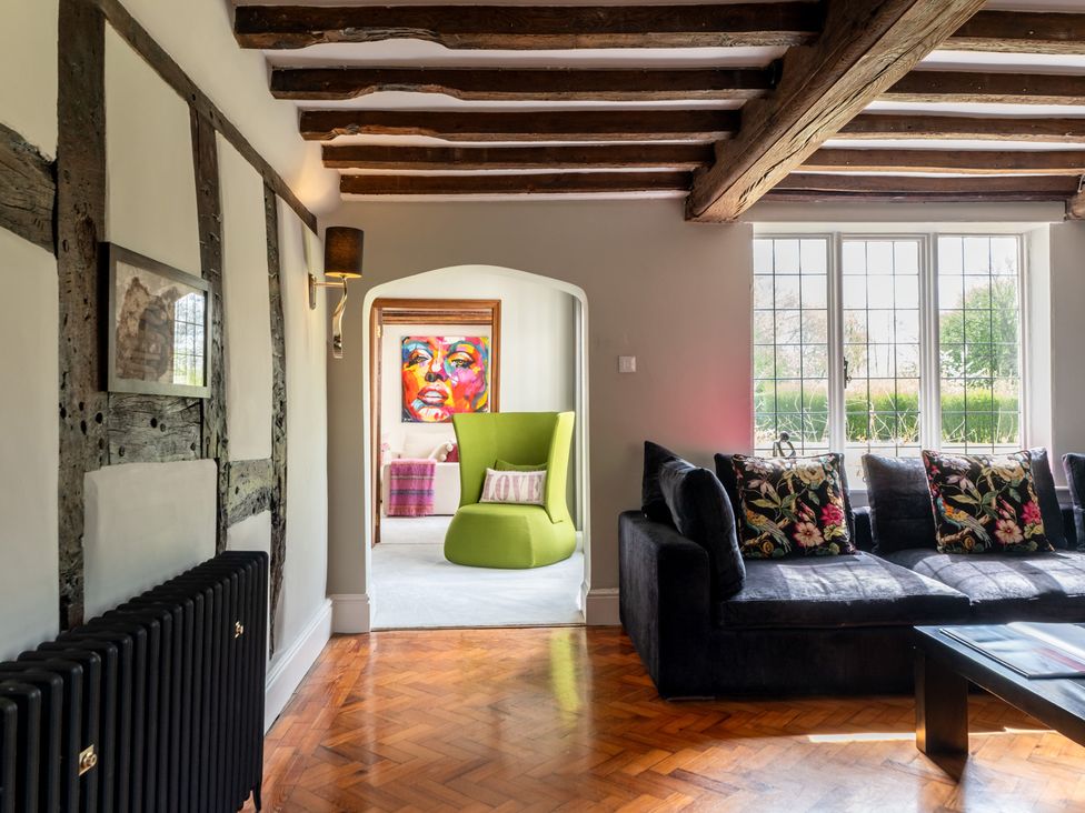 A living room with a sofa and chair at Hall O'Coole in Broomhall nearn Wrenbury