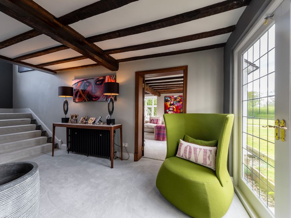 An entrance hall with a staircase and console table at Hall O'Coole in Broomhall nearn Wrenbury