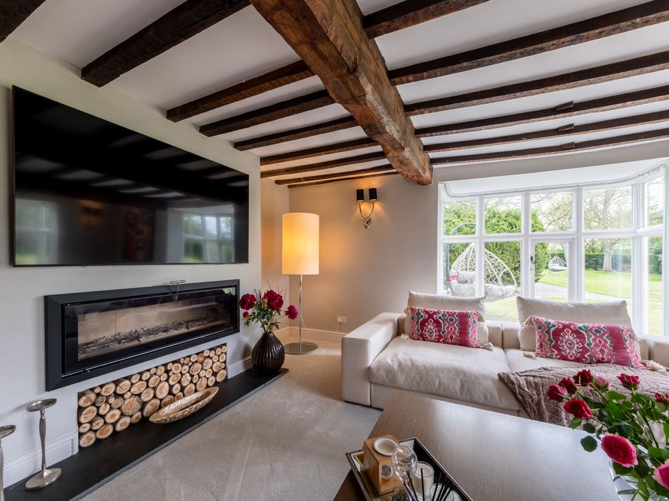 A living room with a television and fireplace at Hall O'Coole in Broomhall nearn Wrenbury