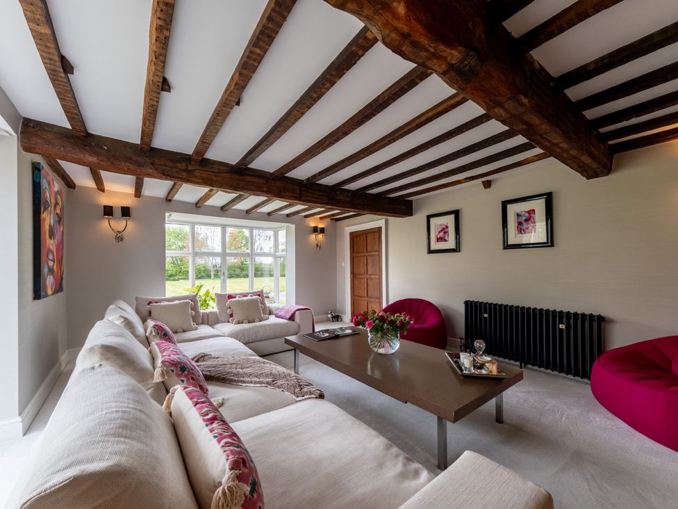 A living room with a sofa, coffee table, and window at Hall O'Coole, Broomhall nearn Wrenbury