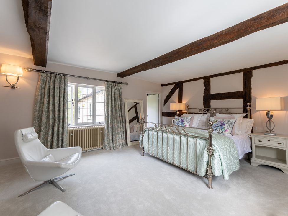 A bedroom with a bed and a chair at Hall O'Coole, Broomhall nearn Wrenbury