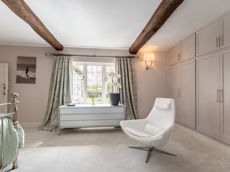 A bedroom with a bed and a storage unit at Hall O'Coole in Broomhall nearn Wrenbury