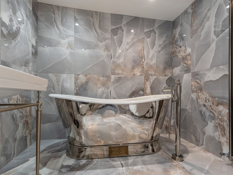 A bathroom with a bathtub and sink at Hall O'Coole Broomhall nearn Wrenbury