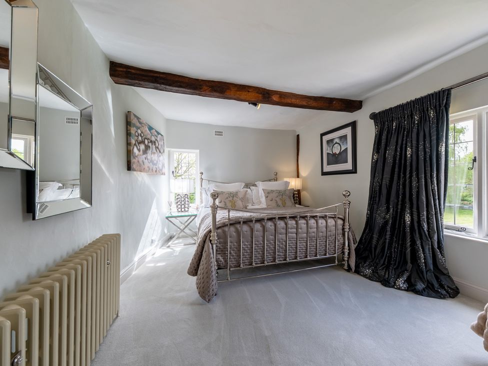 A bedroom with a bed and side table at Hall O'Coole in Broomhall nearn Wrenbury