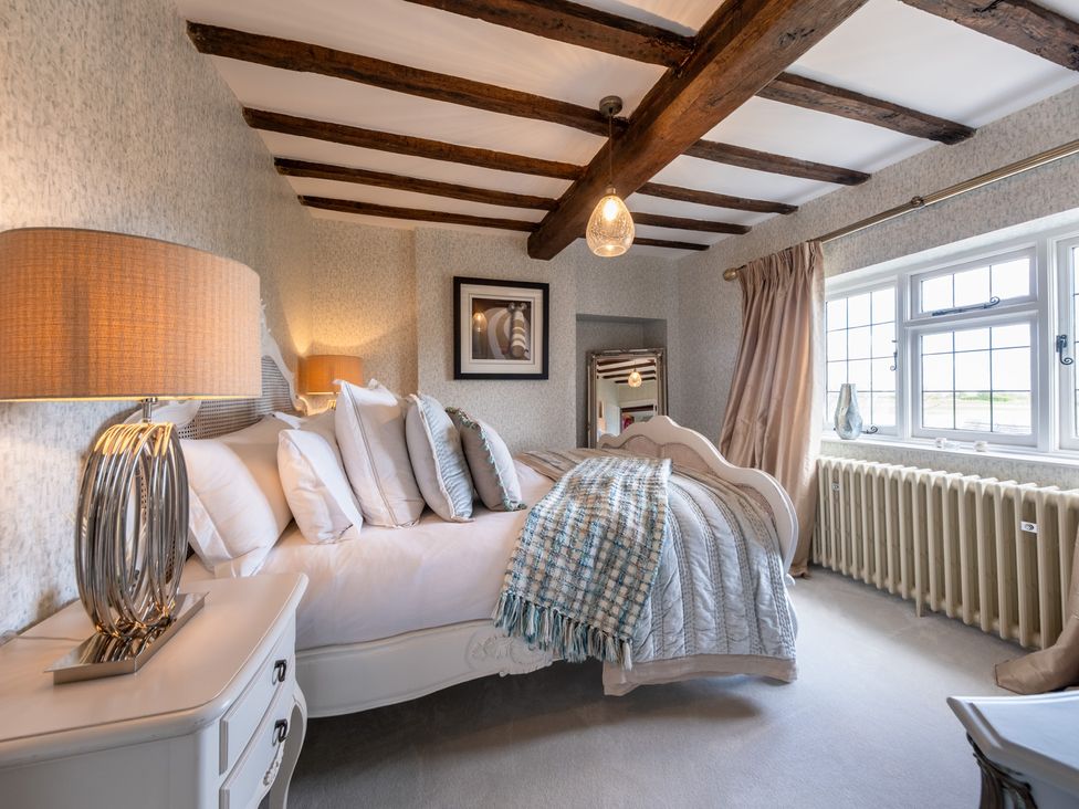 A bedroom with a bed, bedside table, and window at Hall O'Coole Broomhall nearn Wrenbury
