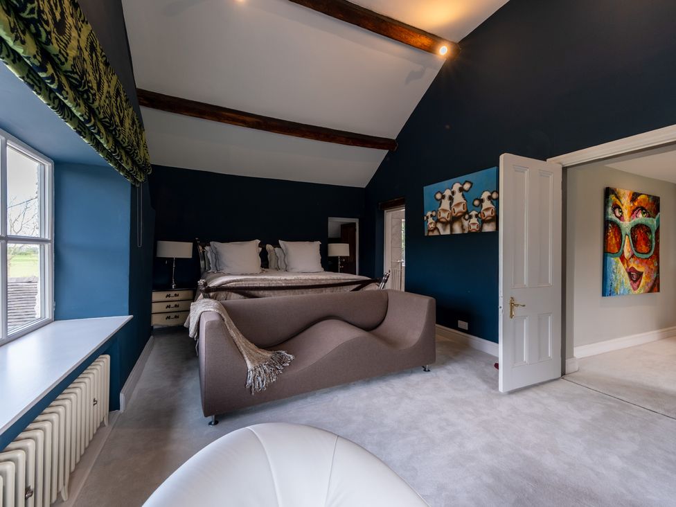 A bedroom with a bed and a sofa at Hall O'Coole in Broomhall nearn Wrenbury