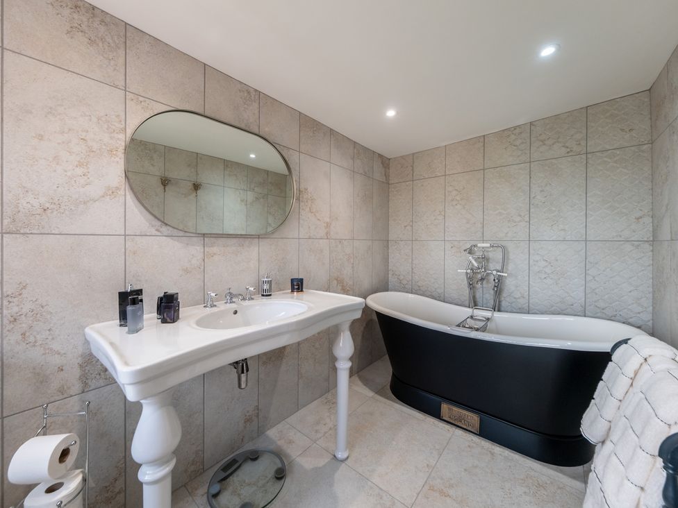 A bathroom with a bathtub and sink at Hall O'Coole in Broomhall nearn Wrenbury