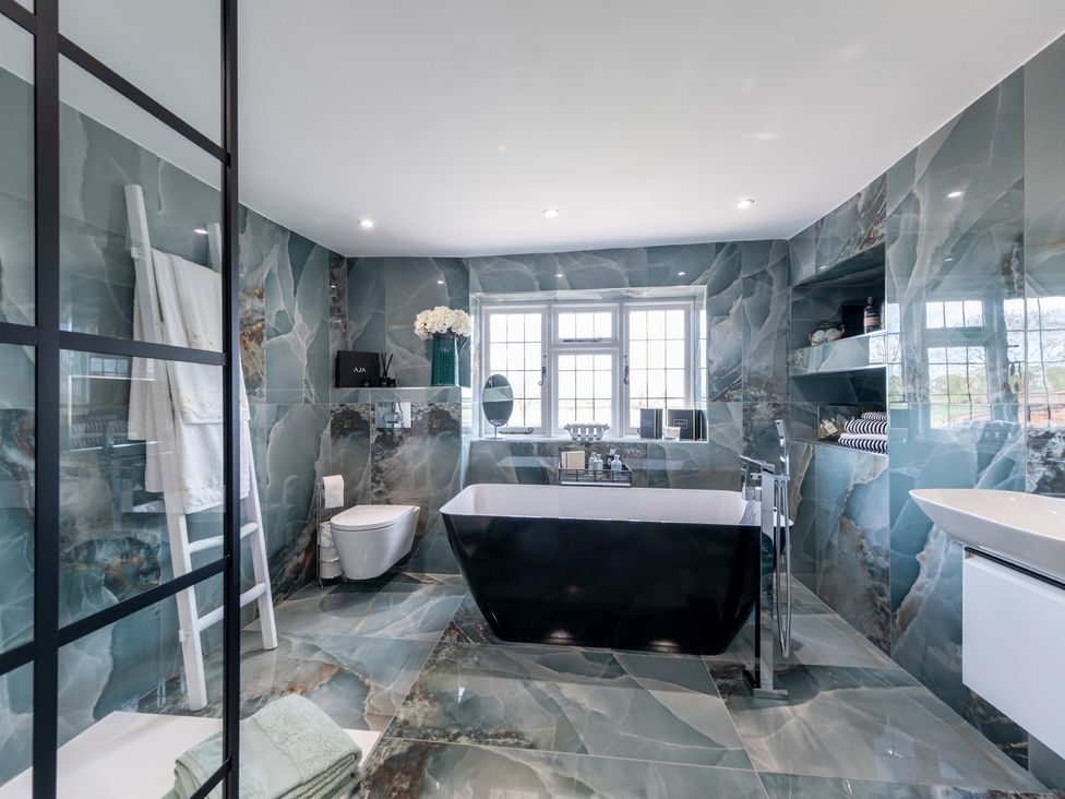 A bathroom with a bathtub, toilet, and sink at Hall O'Coole in Broomhall nearn Wrenbury