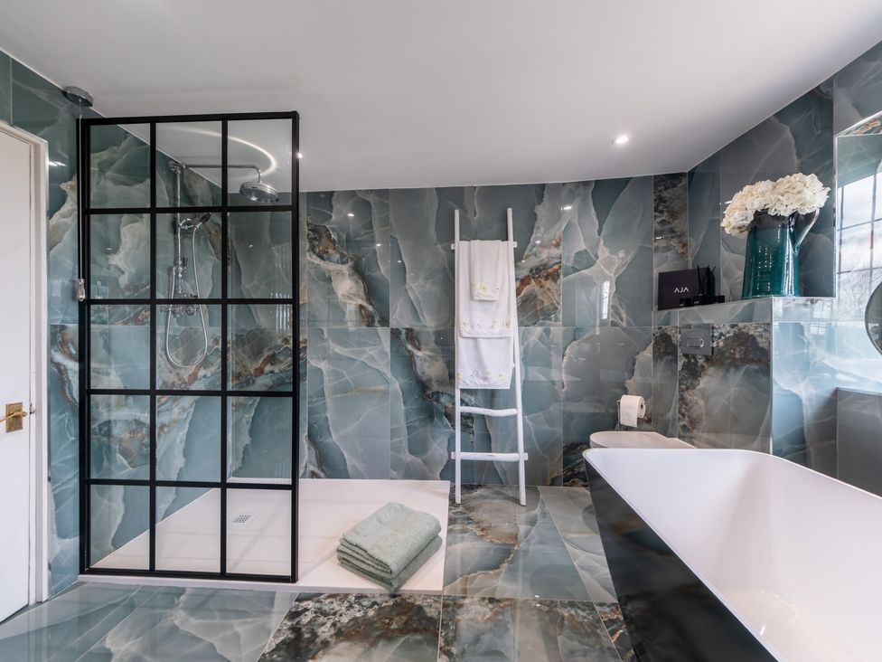 A bathroom with a shower and bathtub at Hall O'Coole Broomhall near Wrenbury