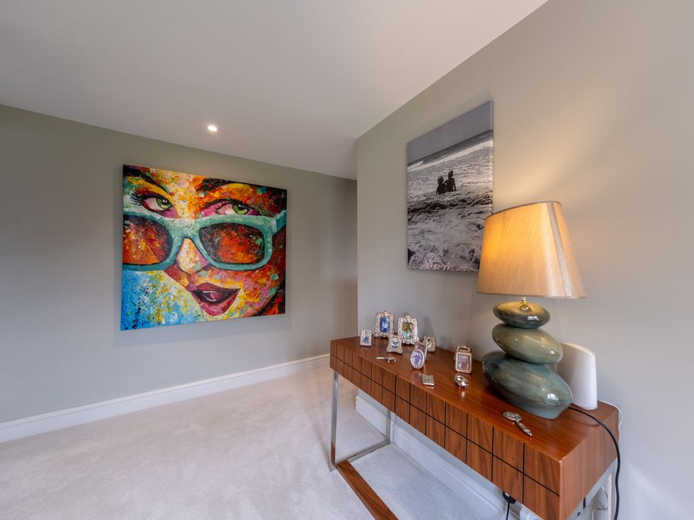 A living room with artwork and a lamp at Hall O'Coole in Broomhall near Wrenbury