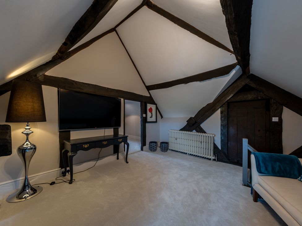 An attic with a television and lamp at Hall O'Coole in Broomhall nearn Wrenbury