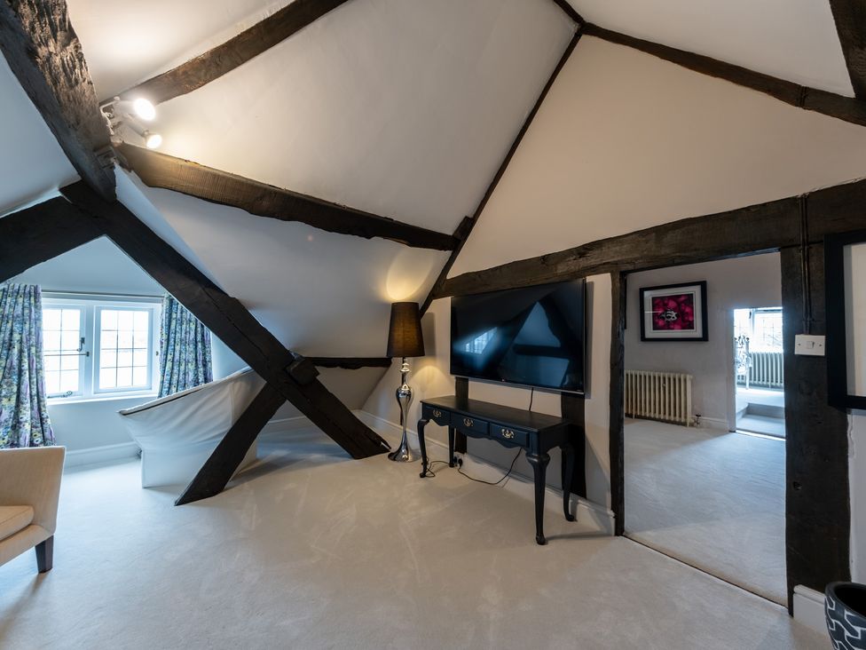 A living room with beams and a television at Hall O'Coole in Broomhall nearn Wrenbury