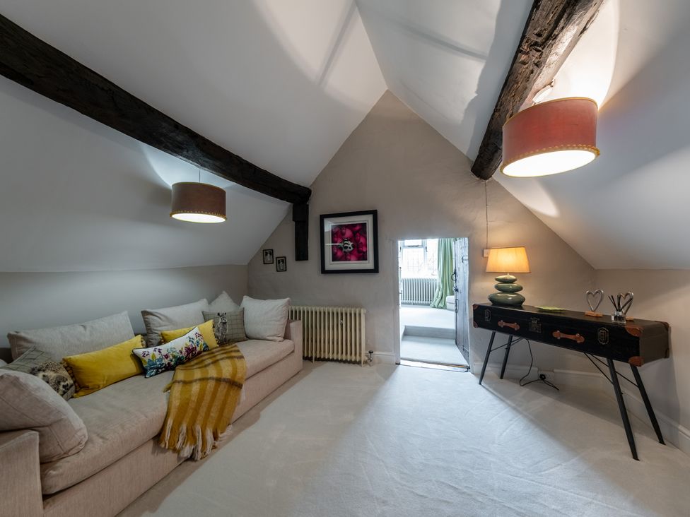 A snug with a sofa and a console table at Hall O'Coole in Broomhall nearn Wrenbury